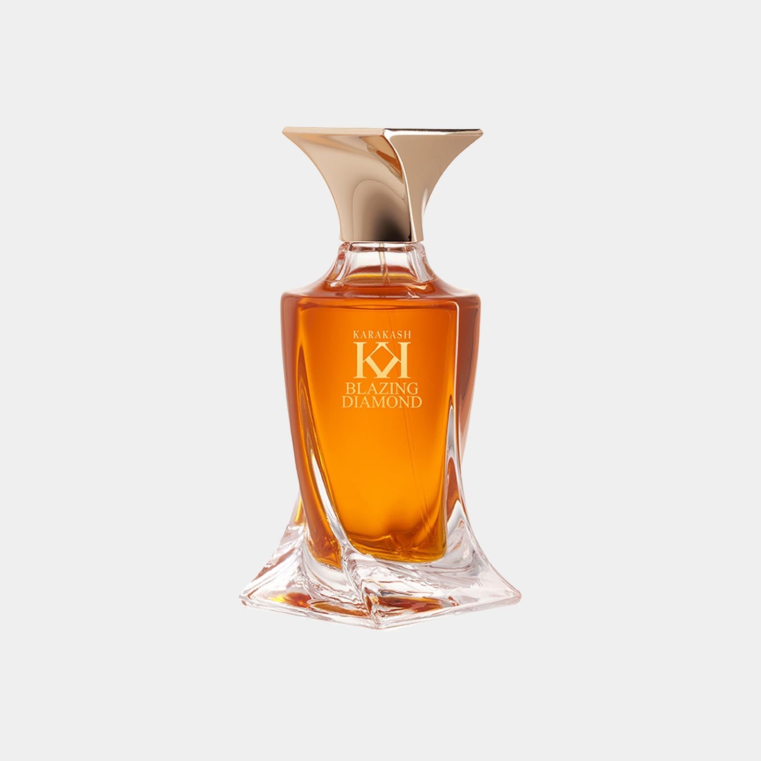 Glass bottle of 'Karakash Blazing Diamond Sample', featuring a unique, elegant design with a gold cap and a rich amber liquid inside. The bottle's shape adds a luxurious touch to the fragrance.