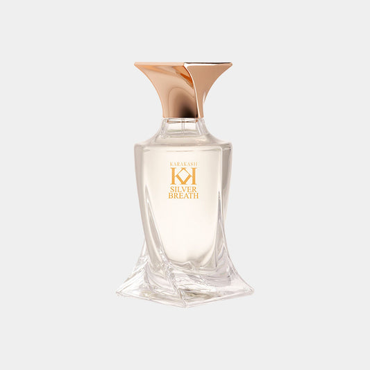 A chic, modern perfume bottle labeled 'Karakash Silver Breath Sample' features a sleek design with a gold cap and a clear body, showcasing the elegant fragrance inside.