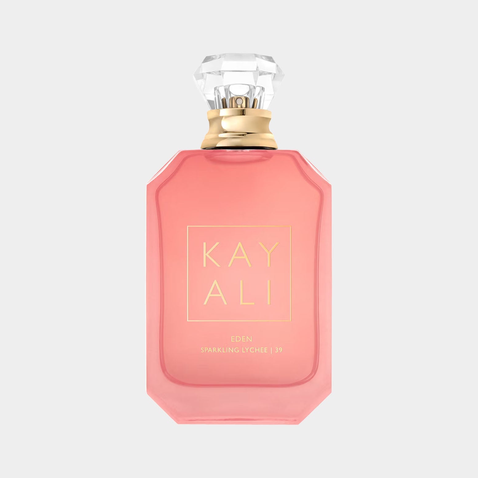 A pink glass perfume bottle labeled Kayali Eden Sparkling Lychee 39 Sample with a faceted crystal cap, exuding elegance and sophistication.