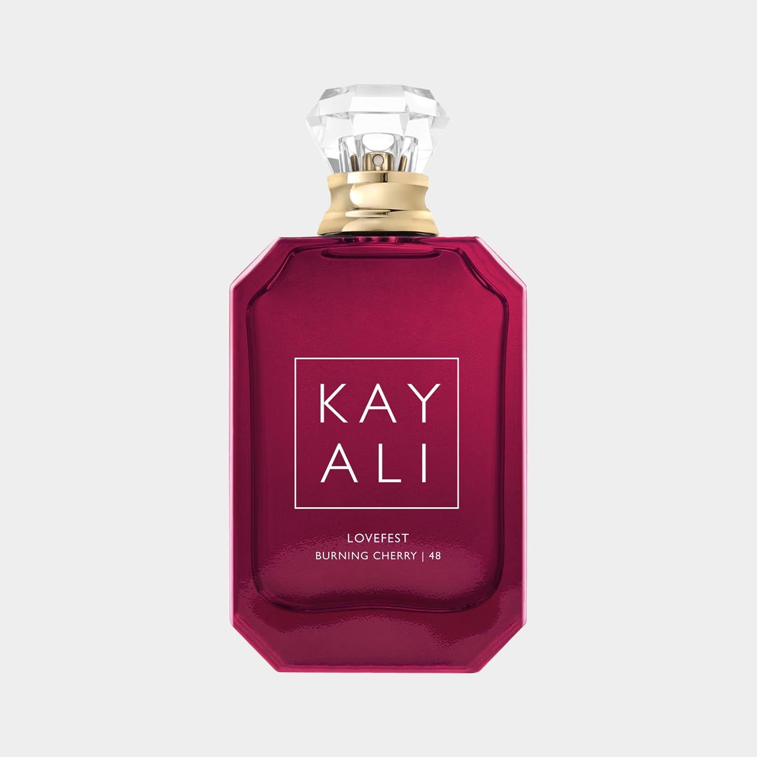 A striking bottle of Kayali Lovefest Burning Cherry 48 sample, featuring a deep red hue and an elegant faceted cap, showcasing the brand name prominently on the front.