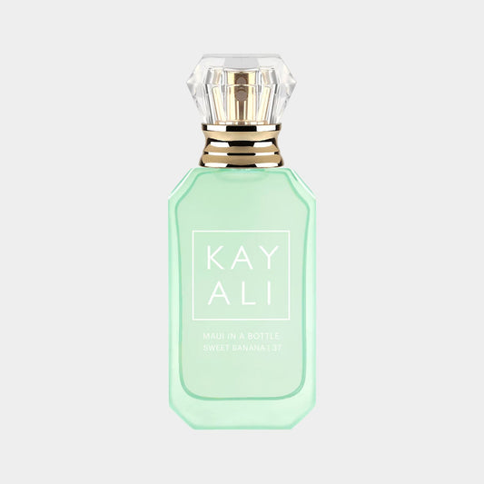 A mint green perfume bottle with a diamond-shaped cap, labeled Kayali Maui In A Bottle Sweet Banana 37. The design is elegant and modern, showcasing the tropical and fruity essence of the fragrance.