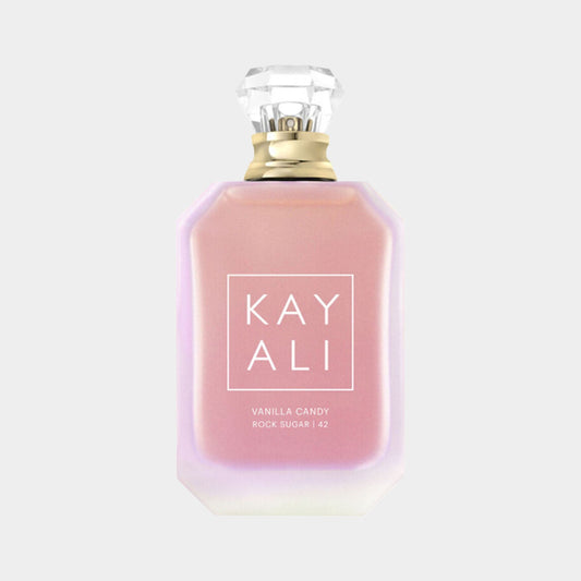 A bottle of Kayali Vanilla Candy Rock Sugar 42 fragrance, featuring an elegant, softly colored design with a crystal-like cap. The label prominently displays the product name in stylish lettering.