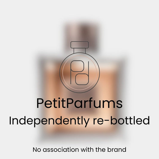 A sample bottle of L'Homme Ideal EDP (2017) presented with a blurred background, featuring a stylish design and label indicating it is independently re-bottled by PetitParfums.