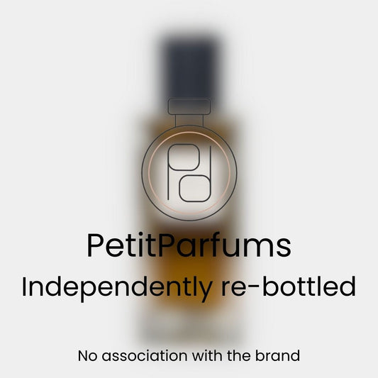A bottle labeled Babycat Sample by PetitParfums, featuring an amber liquid inside, presented against a blurred background. The text notes that it is independently re-bottled with no association to the original brand.
