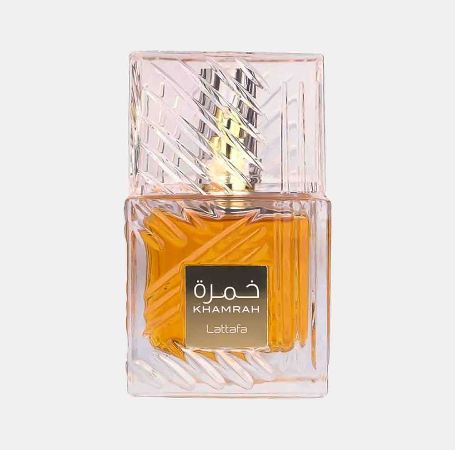 A clear glass bottle with an intricate design containing Lattafa Perfumes Khamrah Sample, featuring a golden-yellow fragrance. The label displays the name Khamrah prominently.