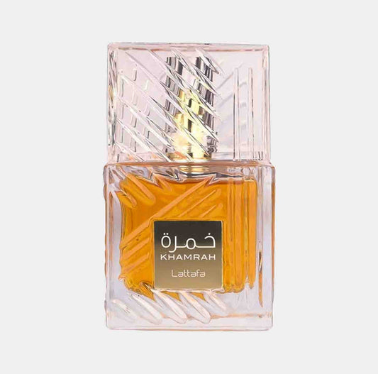 A full bottle of Lattafa Perfumes Khamrah, featuring a unique textured glass design with a golden-yellow fragrance visible inside. The bottle is topped with an elegant cap and labeled prominently.