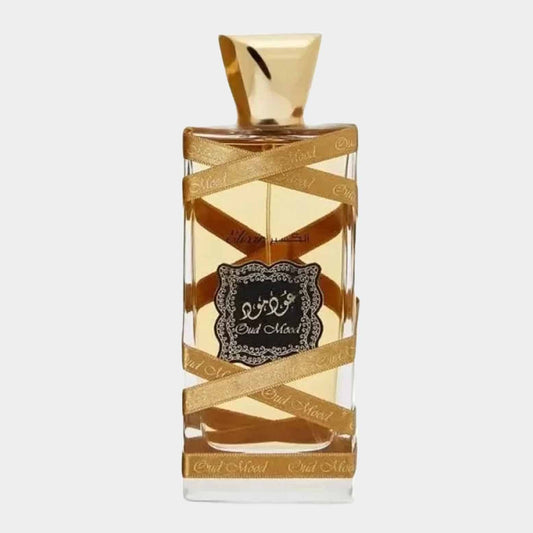 A clear bottle of Lattafa Oud Mood Elixir Sample, featuring an intricate label and gold ribbon accents, showcasing a warm, amber-colored fragrance.