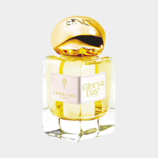 A sleek glass bottle of Lengling Glorya Day perfume featuring a gold cap and an elegant label. The fragrance is a warm yellow color, hinting at its vibrant and uplifting nature.