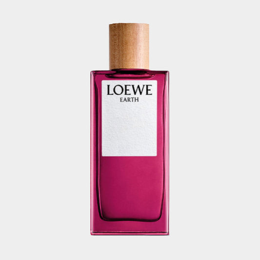 A sleek, rectangular bottle of Loewe Earth Sample, featuring a vibrant pink hue and a wooden cap. The front label prominently displays the brand name Loewe and the product name Earth.