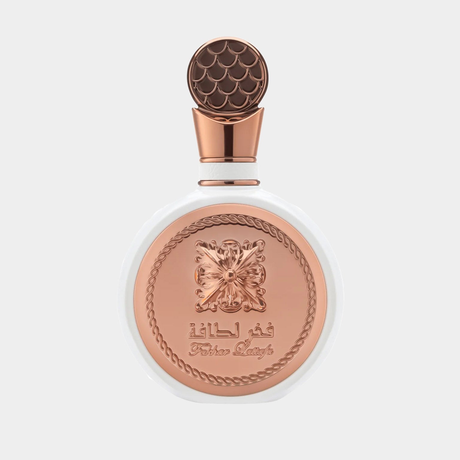 A beautifully designed bottle of Lattafa Perfumes Fakhar Rose Sample, featuring a white base and an ornate copper lid with intricate detailing. The elegant label showcases the brand name prominently.