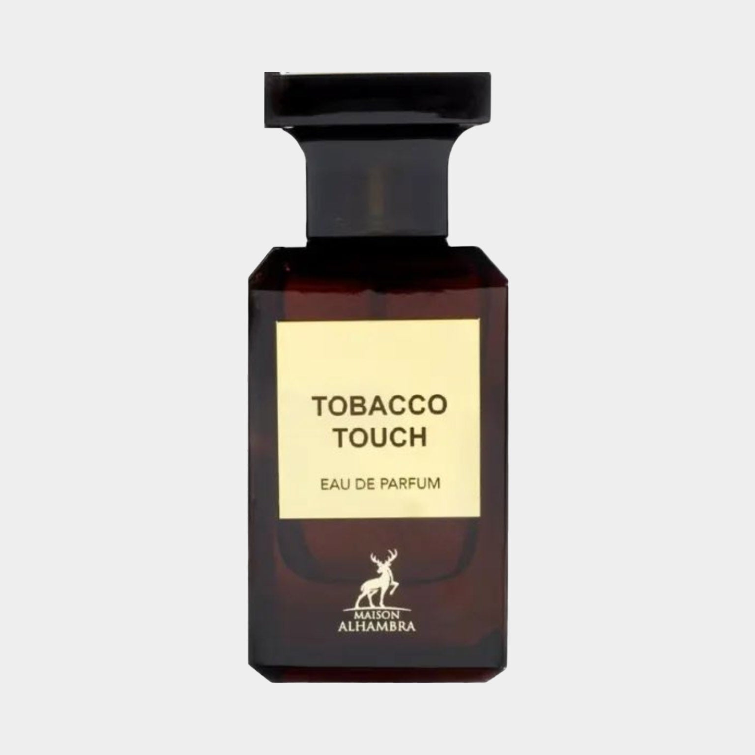 A close-up of the Maison Alhambra Tobacco Touch sample bottle, featuring a dark amber glass design with a label that reads TOBACCO TOUCH and Eau de Parfum. The elegant bottle is topped with a sleek black cap.