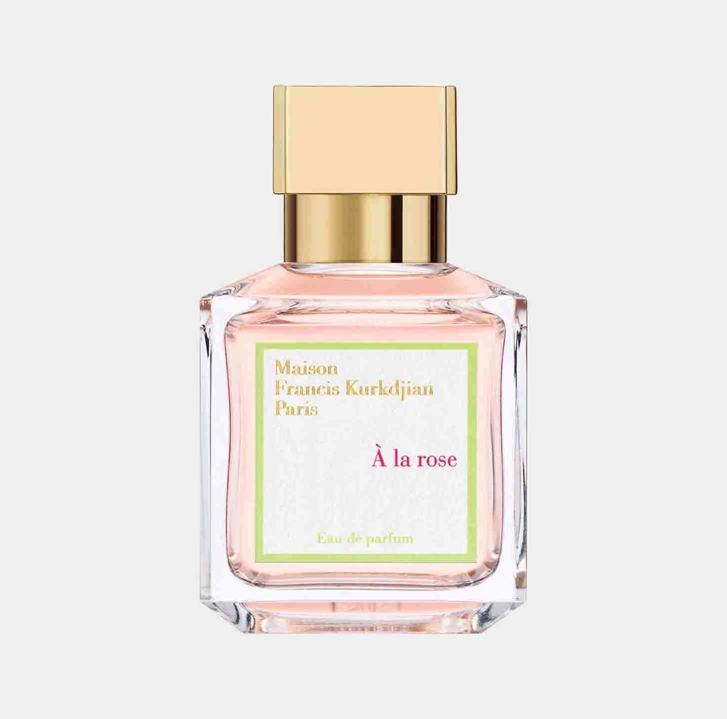 A Maison Francis Kurkdjian À La Rose sample bottle featuring a delicate pink fragrance in a clear glass container, topped with a gold cap. The label showcases the brand and perfume name in elegant lettering.
