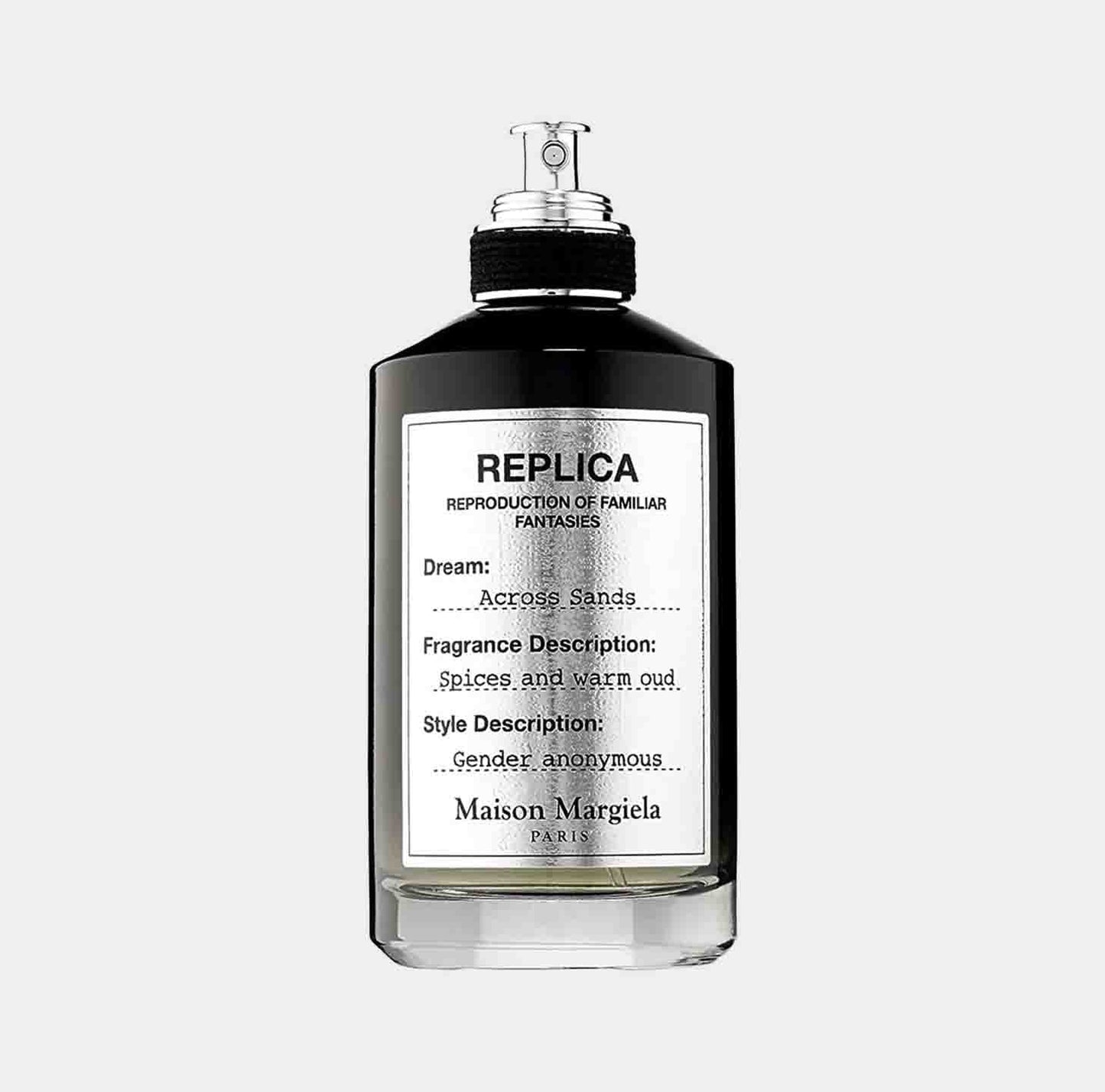 A sleek bottle of Maison Martin Margiela Replica Across Sands Sample, featuring a minimalist design with a black cap and a label that describes the fragrance as a blend of spices and warm oud. The bottle embodies a gender-neutral aesthetic.