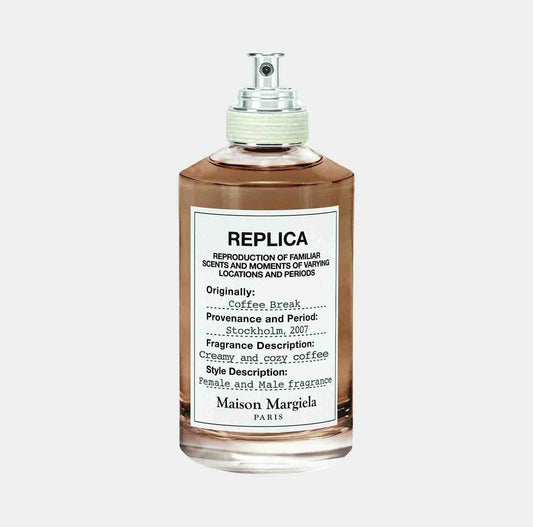 Maison Martin Margiela Replica Coffee Break Sample, featuring a transparent glass bottle with a silver spray nozzle, labeled with notes on its origins and fragrance description highlighting creamy and cozy coffee.