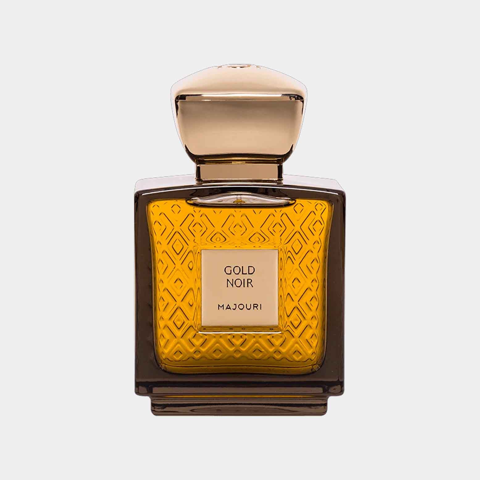 A sleek bottle of Majouri Gold Noir Sample, featuring an intricate gold-patterned design and a smooth, rounded cap, filled with a rich amber liquid.
