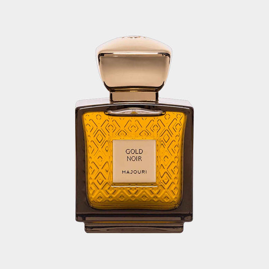 A sleek bottle of Majouri Gold Noir Sample, featuring an intricate gold-patterned design and a smooth, rounded cap, filled with a rich amber liquid.