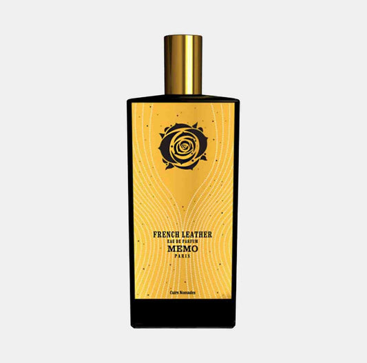 A sleek black perfume bottle with a golden cap, featuring an elegant yellow label adorned with a rose design, labeled Memo Paris French Leather Sample.