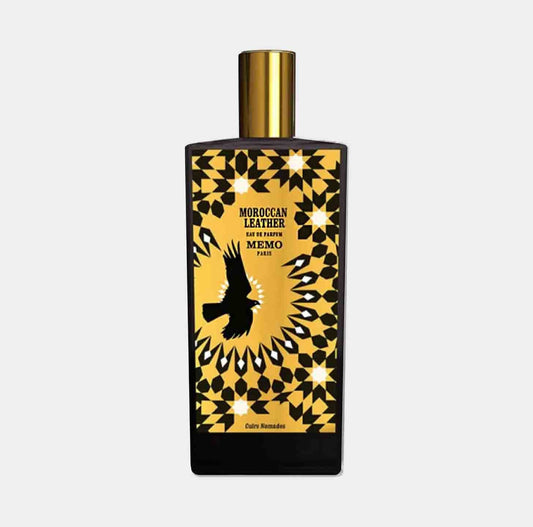 A sleek bottle of Memo Paris Moroccan Leather Sample, featuring a striking black and gold design with a prominent eagle motif, showcasing its luxurious fragrance.