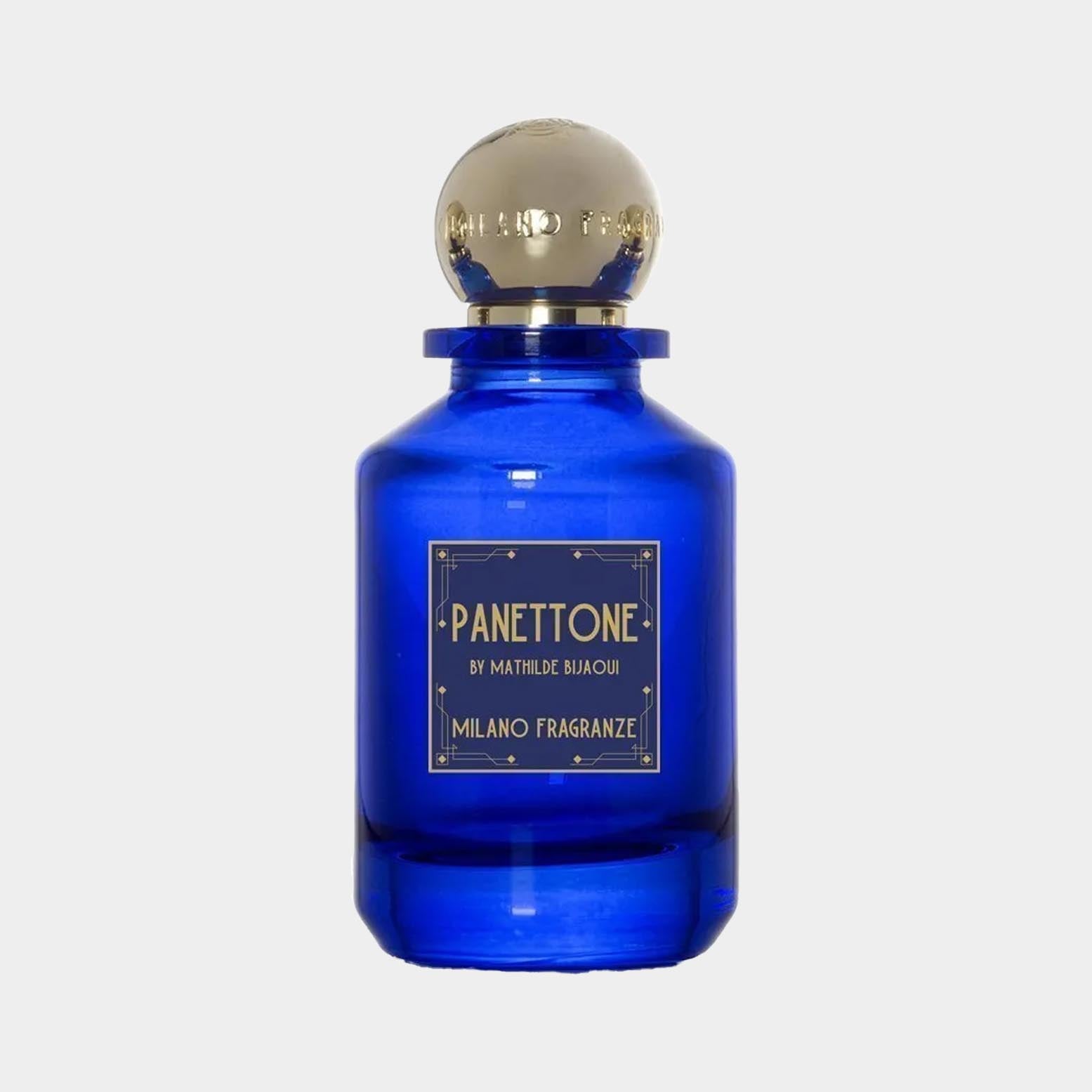 A deep blue bottle of Milano Fragranze Panettone Sample, featuring an elegant gold cap and a label that details the fragrance by Mathilde Bijaoui. The bottle's classic design highlights its luxurious essence.