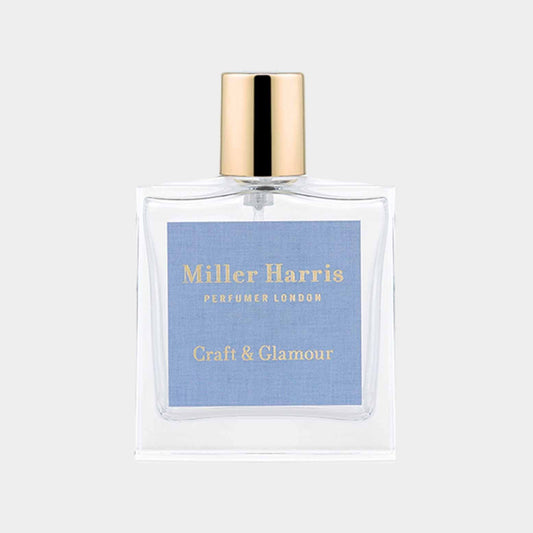 A sample bottle of Miller Harris Craft & Glamour fragrance, featuring a clear glass design and a sleek gold cap, with a blue label showcasing the brand and scent name.
