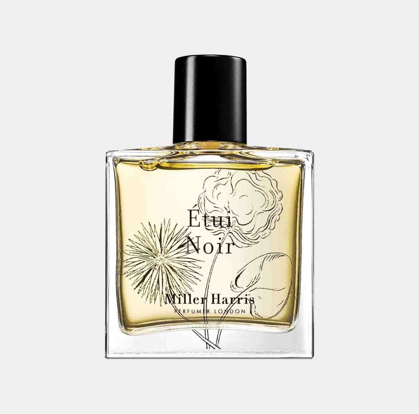 A clear glass bottle of Miller Harris Étui Noir perfume, featuring an elegantly illustrated label with floral and botanical designs. The yellow liquid inside the bottle reflects its exquisite fragrance.