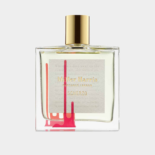 A transparent perfume bottle labeled 'Miller Harris Scherzo Sample' featuring a gold cap and an artistic splash of pink on the side, showcasing a delicate fragrance within.