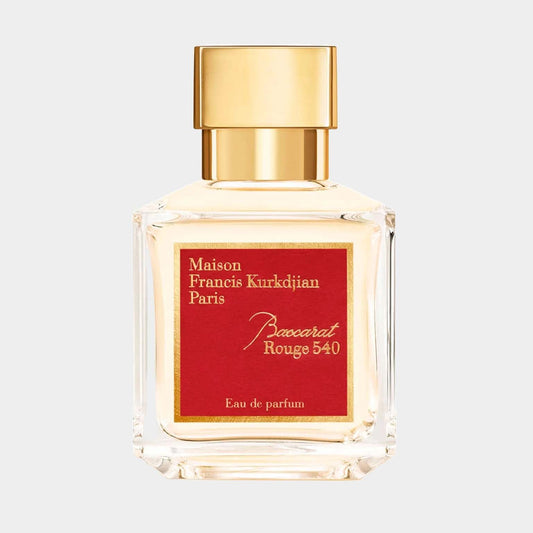 A clear glass bottle of Maison Francis Kurkdjian Baccarat Rouge 540 EDP Sample, featuring a striking red label and a gold cap, elegantly showcasing the luxurious fragrance inside.