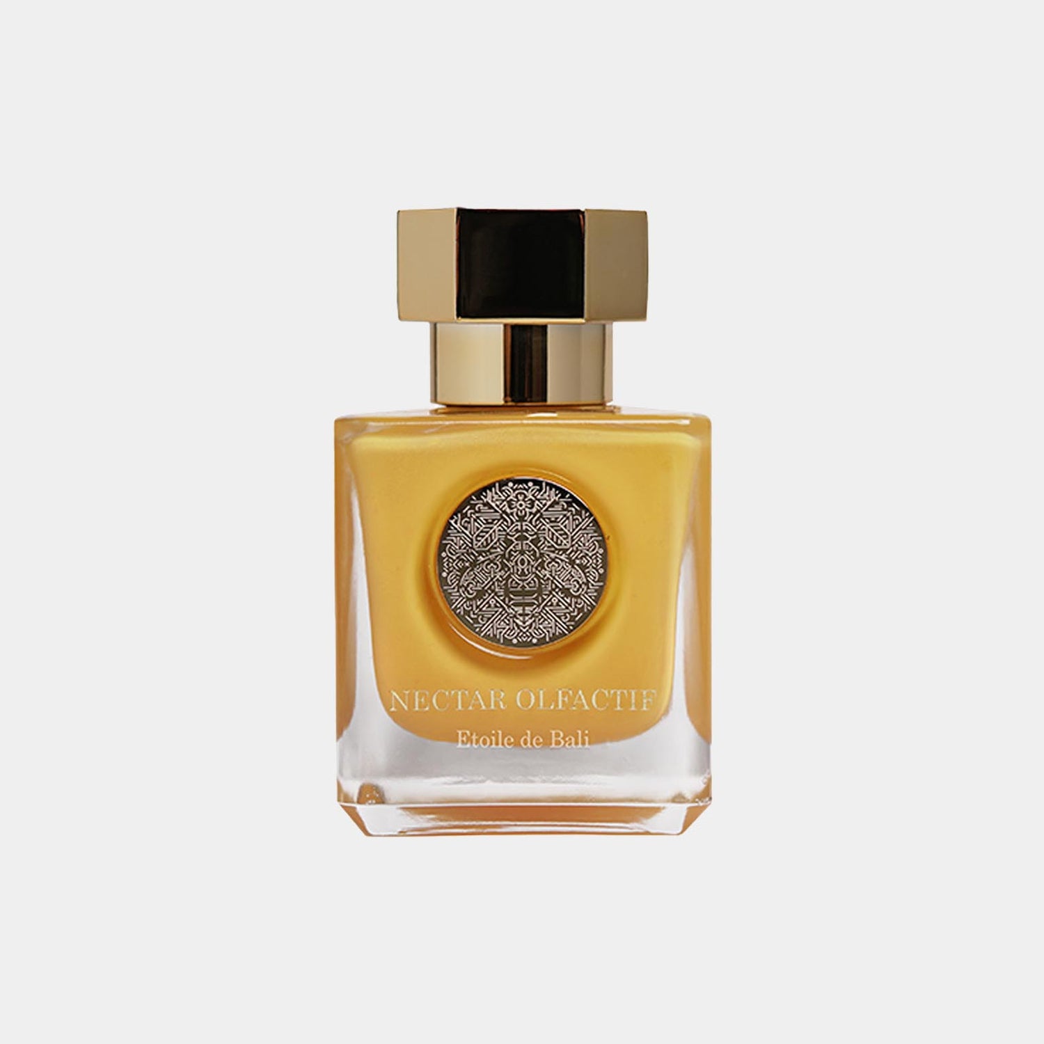 A sleek, elegant perfume bottle of Nectar Olfactif Etoile de Bali Sample, featuring a golden-yellow liquid and a decorative silver medallion on the front. The bottle has a modern design with a square cap and a luxurious appearance.
