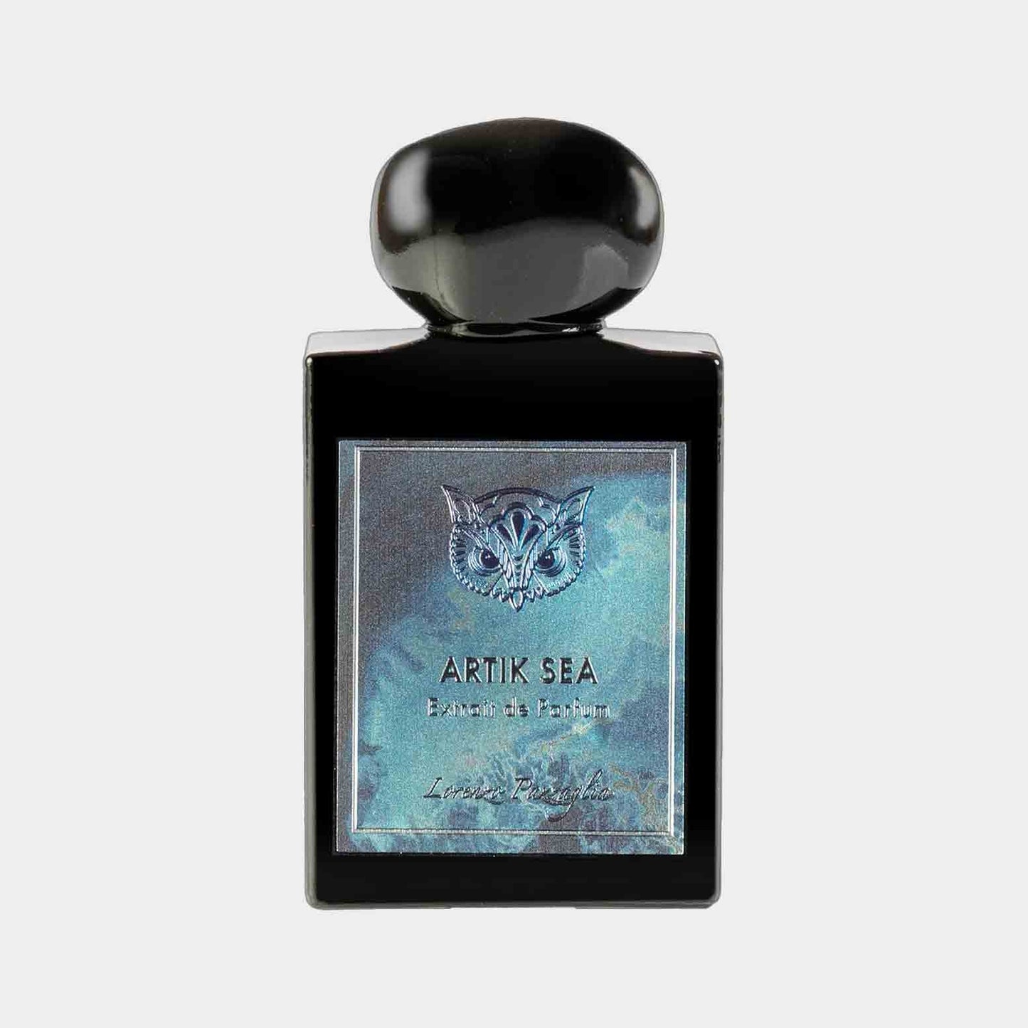 A sleek black perfume bottle labeled 'Lorenzo Pazzaglia Artik Sea Sample,' featuring an elegant owl design on the front. The bottle has a rounded black cap and showcases a shimmering blue background.