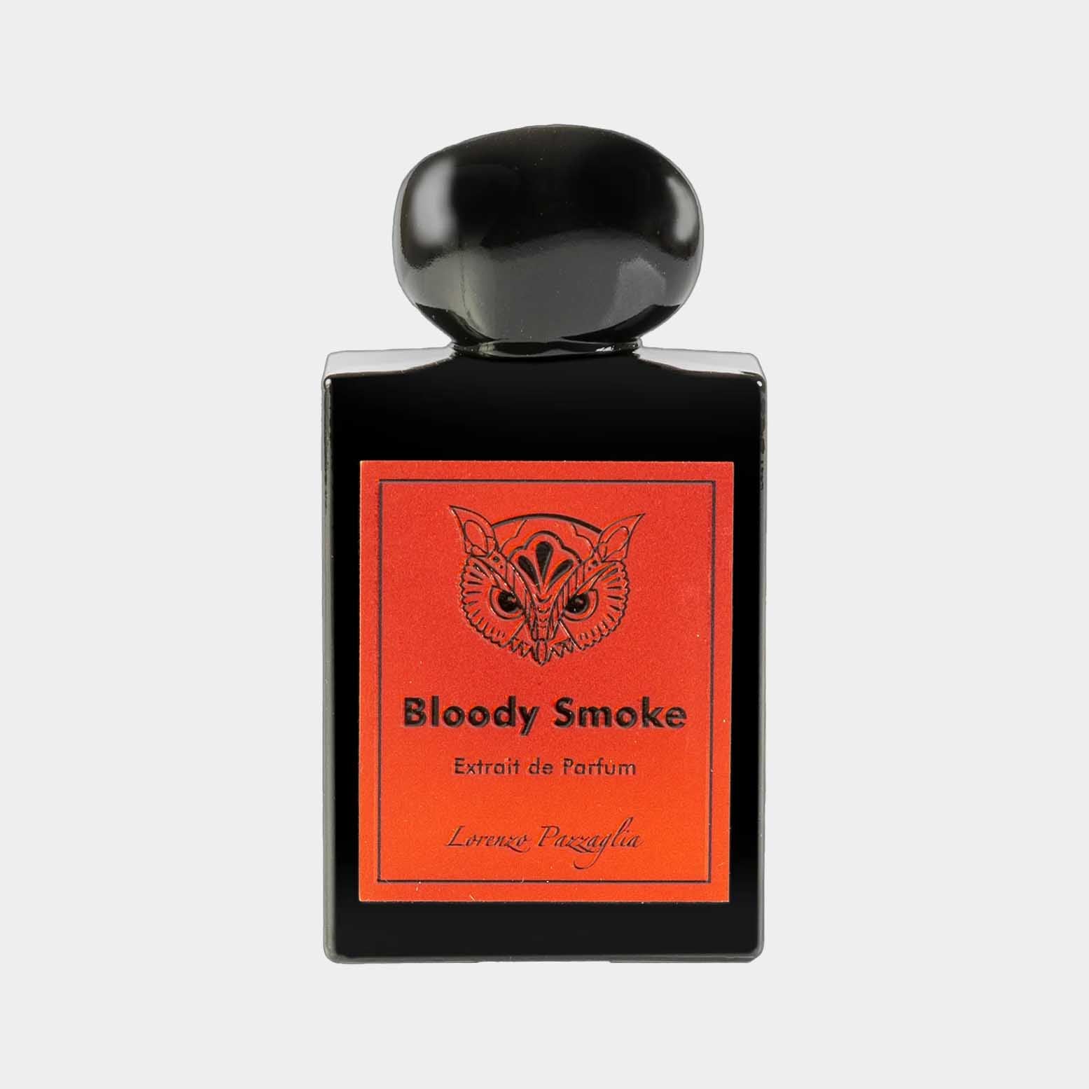 A sleek black perfume bottle with a round cap, featuring a vibrant red label that reads Bloody Smoke Extrait de Parfum by Lorenzo Pazzaglia. The design showcases a striking owl graphic, adding a unique touch to the packaging.