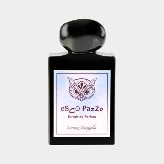 A sleek black perfume bottle with a round cap, featuring a label that reads Lorenzo Pazzaglia Esco Pazzo Extrait de Parfum, adorned with an artistic owl design.