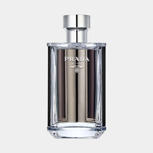 A sleek, modern bottle of Prada L'homme EDT Sample, featuring a clear glass design with silver accents and the brand's logo prominently displayed. The elegant shape and minimalistic style reflect the fragrance's sophisticated nature.