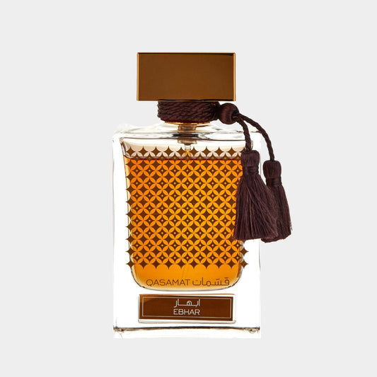 A full bottle of Rasasi Qasamat Ebhar perfume, featuring an ornate glass design with a geometric pattern and a brown tassel, showcasing a warm amber liquid inside.