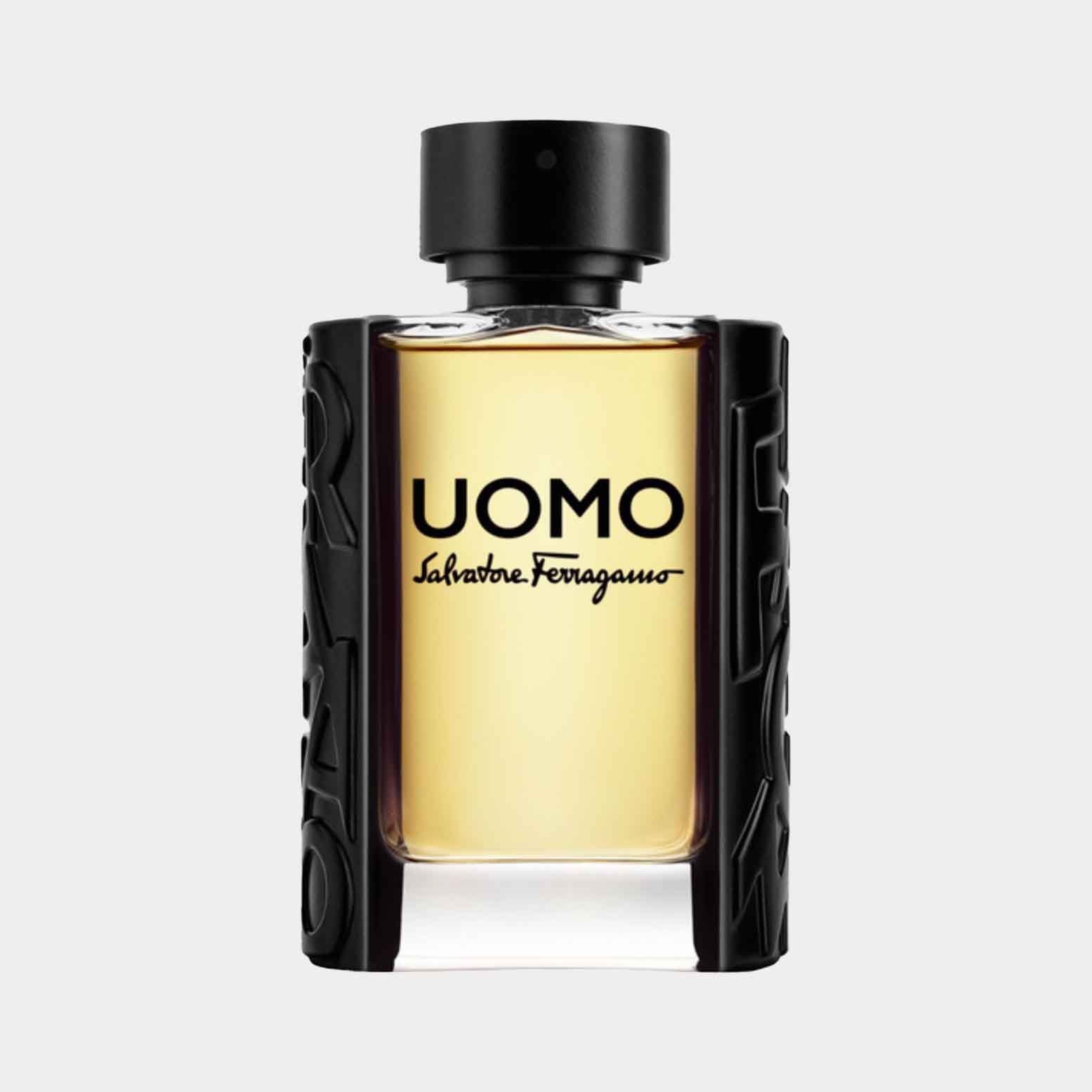 Salvatore Ferragamo Uomo EDT Sample is presented in a stylish black and transparent bottle, showcasing the golden liquid inside. The design features the bold UOMO logo prominently on the front.