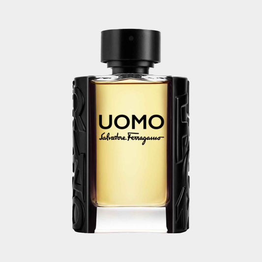 Salvatore Ferragamo Uomo EDT Sample is presented in a stylish black and transparent bottle, showcasing the golden liquid inside. The design features the bold UOMO logo prominently on the front.