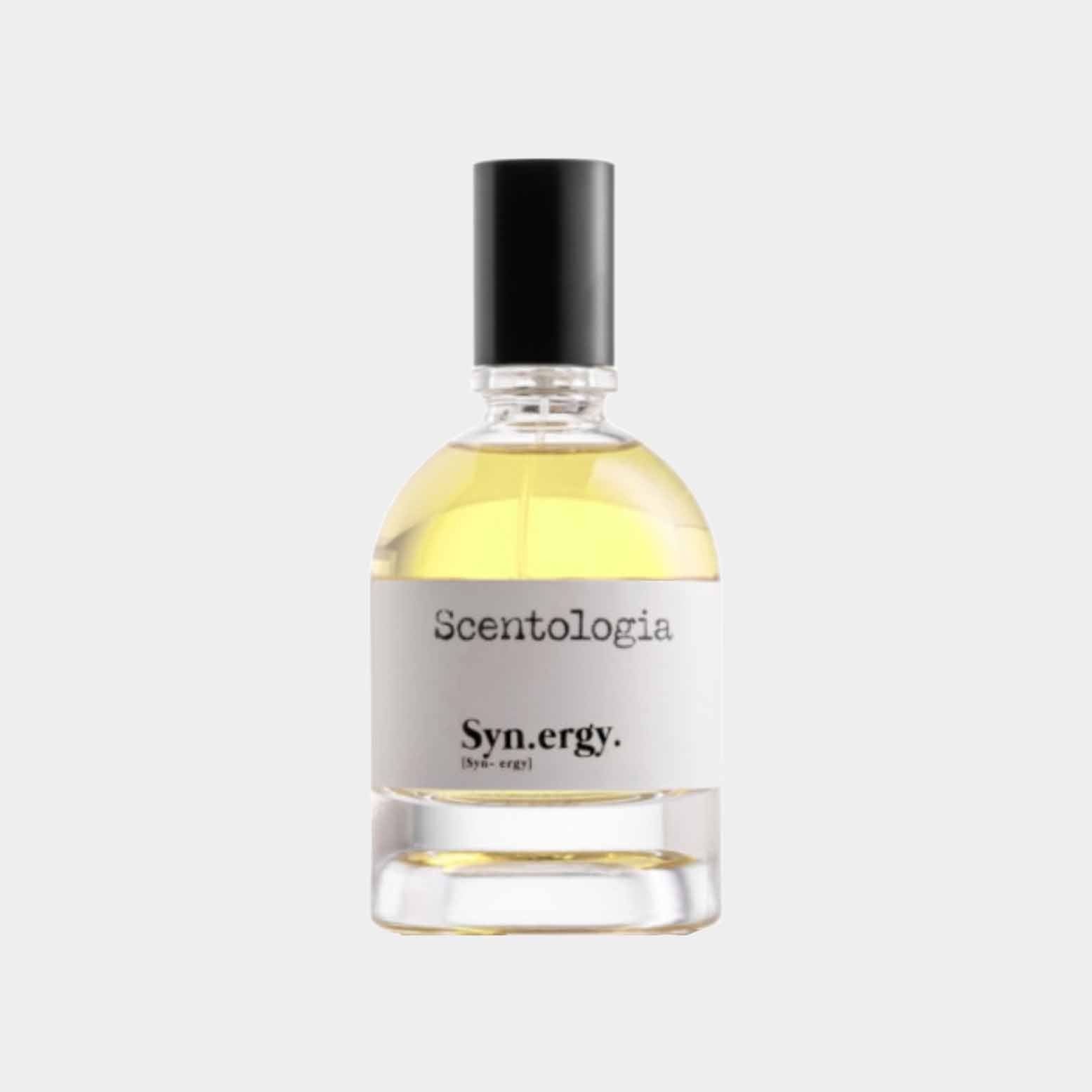 A clear glass bottle of Scentologia Syn.ergy Sample featuring a slender neck and black cap, showcasing a light yellow fragrance inside. The label is minimalist, displaying the brand name and product title.