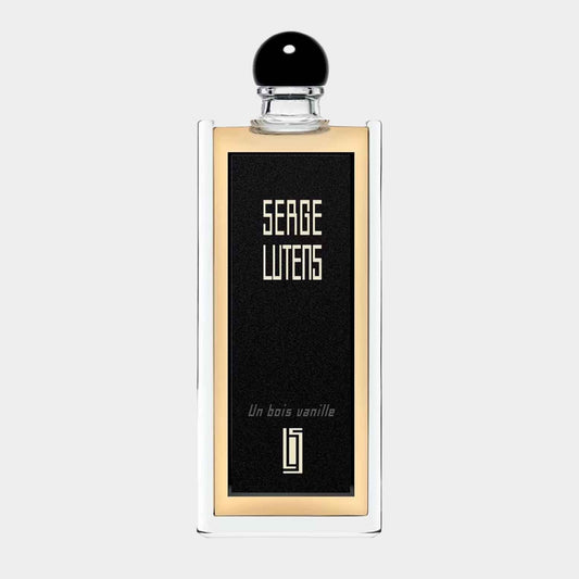 A sample bottle of Serge Lutens Un Bois Vanille EDP, featuring a sleek design with a black and gold label and a round black cap. The bottle reflects a luxurious fragrance experience.