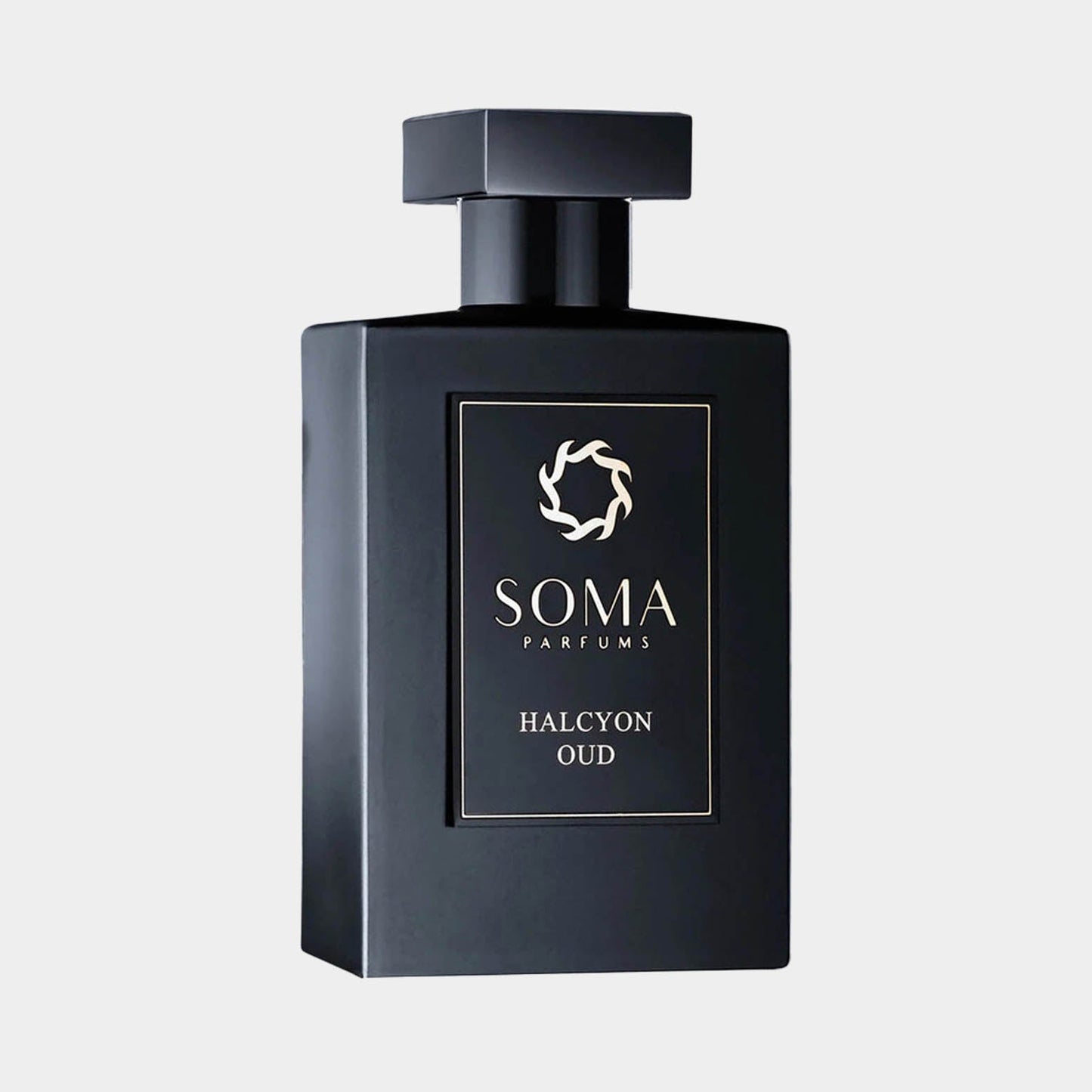 Black rectangular bottle of Soma Parfums Halcyon Oud Sample, featuring a sleek design and a minimalist logo on the front. The bottle is capped with a square top, emphasizing its elegant and modern aesthetic.