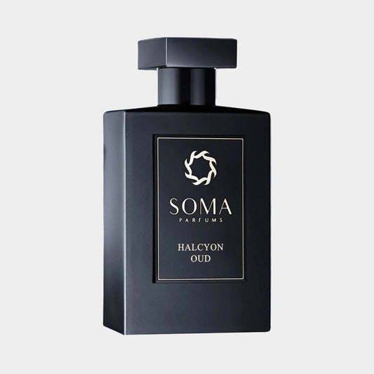 Black rectangular bottle of Soma Parfums Halcyon Oud Sample, featuring a sleek design and a minimalist logo on the front. The bottle is capped with a square top, emphasizing its elegant and modern aesthetic.