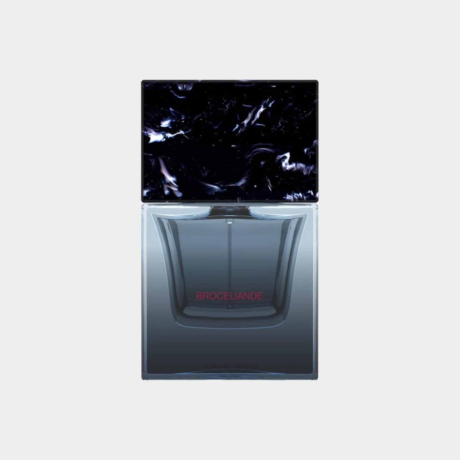 A sleek glass bottle of Sora Dora Broceliande fragrance, featuring a dark, marble-like cap and subtle branding on the front. The design is modern and elegant, emphasizing the luxurious essence of the perfume.