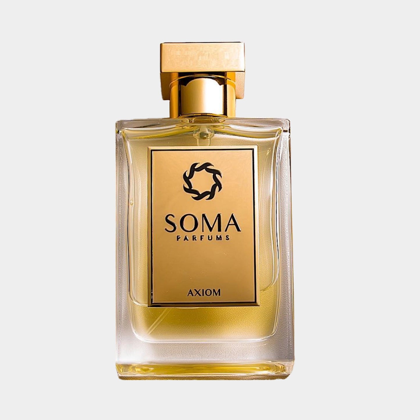 A Soma Parfums Axiom sample bottle, featuring a sleek glass design with a golden cap and a label showcasing the brand name and fragrance title. The liquid inside is a warm, golden hue.