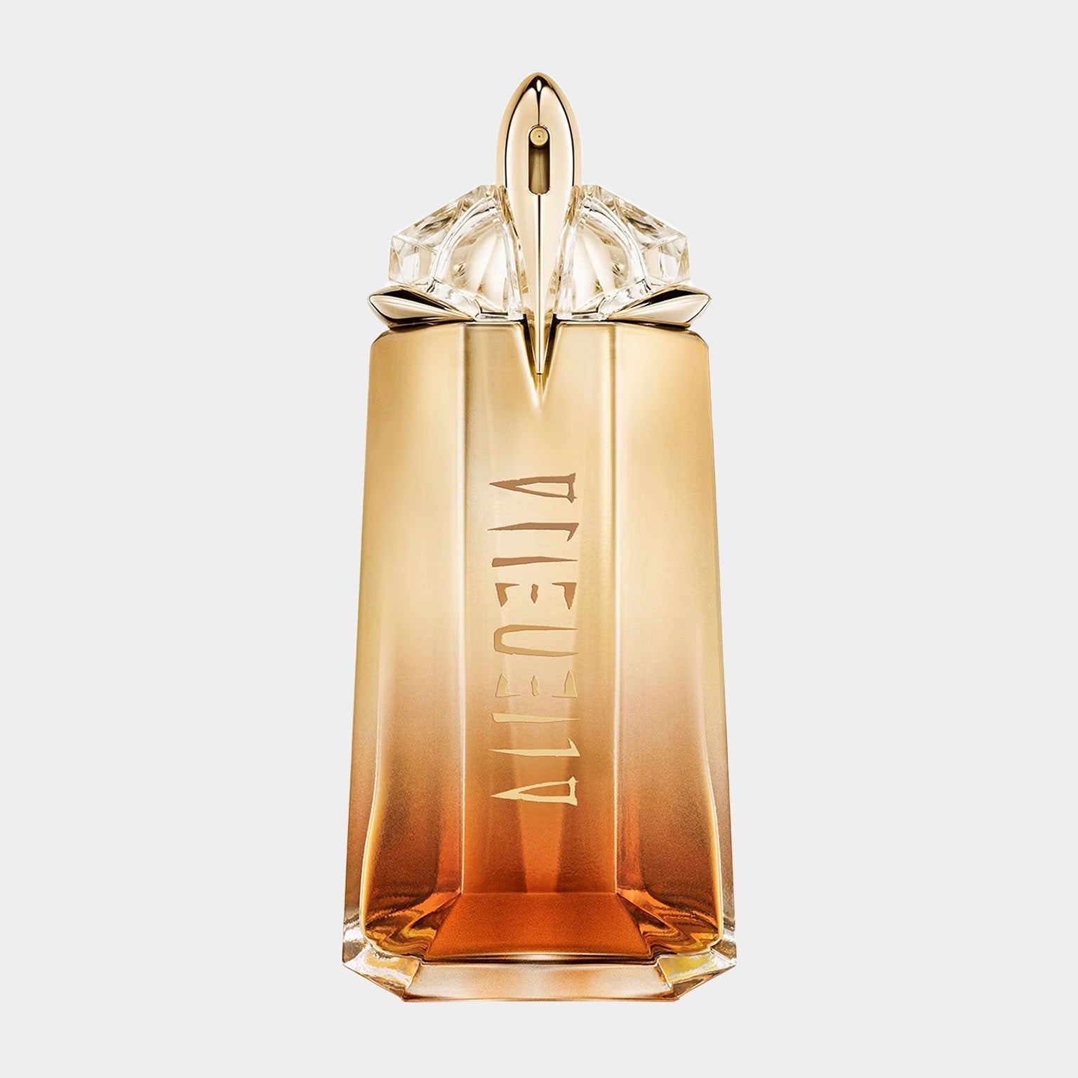 A bottle of Thierry Mugler Alien Goddess Intense Eau de Parfum sample, featuring a striking design with a golden gradient, intricate cap, and the brand name elegantly embossed on the front.