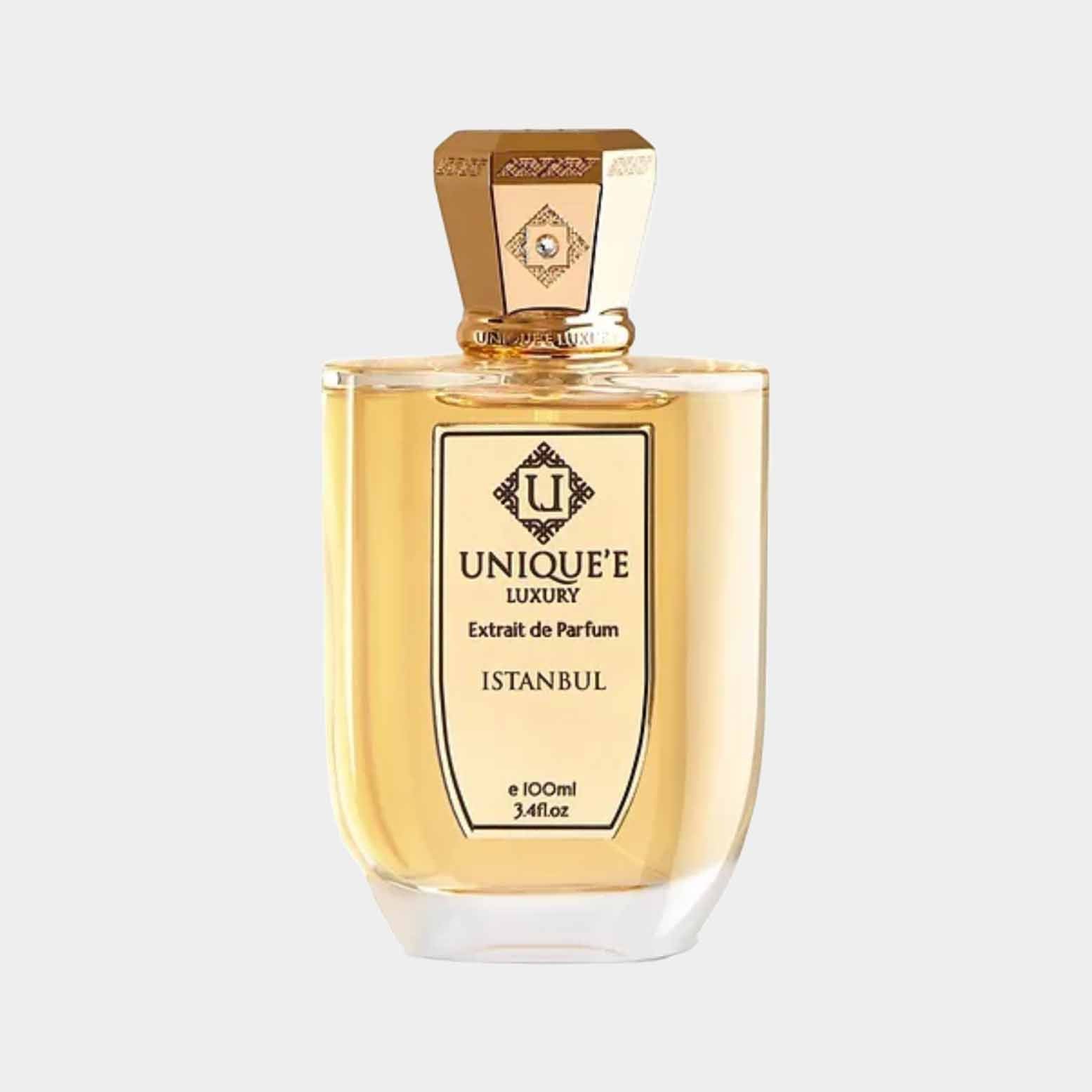 A full bottle of Unique'e Luxury Istanbul Extrait de Parfum, featuring an elegant design with a golden liquid and a distinctive hexagonal cap. The label prominently displays the brand name and fragrance name, showcasing its luxurious appeal.