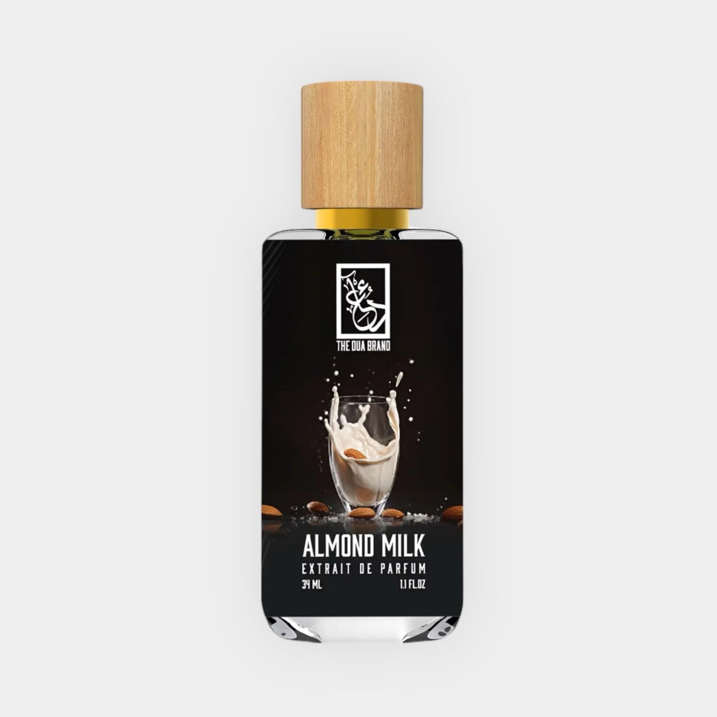 Almond Milk Sample from Dua, featuring a sleek bottle with a wooden cap, showcasing a splash of almond milk amidst almonds. The label emphasizes its luxurious and fragrant qualities as an extrait de parfum.