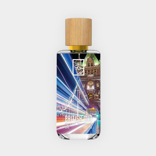 Dua British Oud Sample is a glass fragrance bottle featuring a sleek design and a natural wooden cap. The label showcases vibrant city lights, suggesting an urban and sophisticated scent experience.