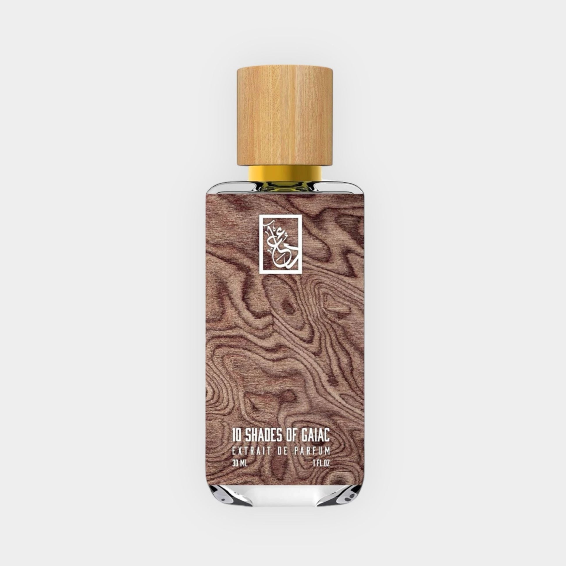 A bottle of Dua 10 Shades of Gaiac perfume, featuring a wooden cap and a sleek design with a textured wood background, contained in a 3 ml glass vial.
