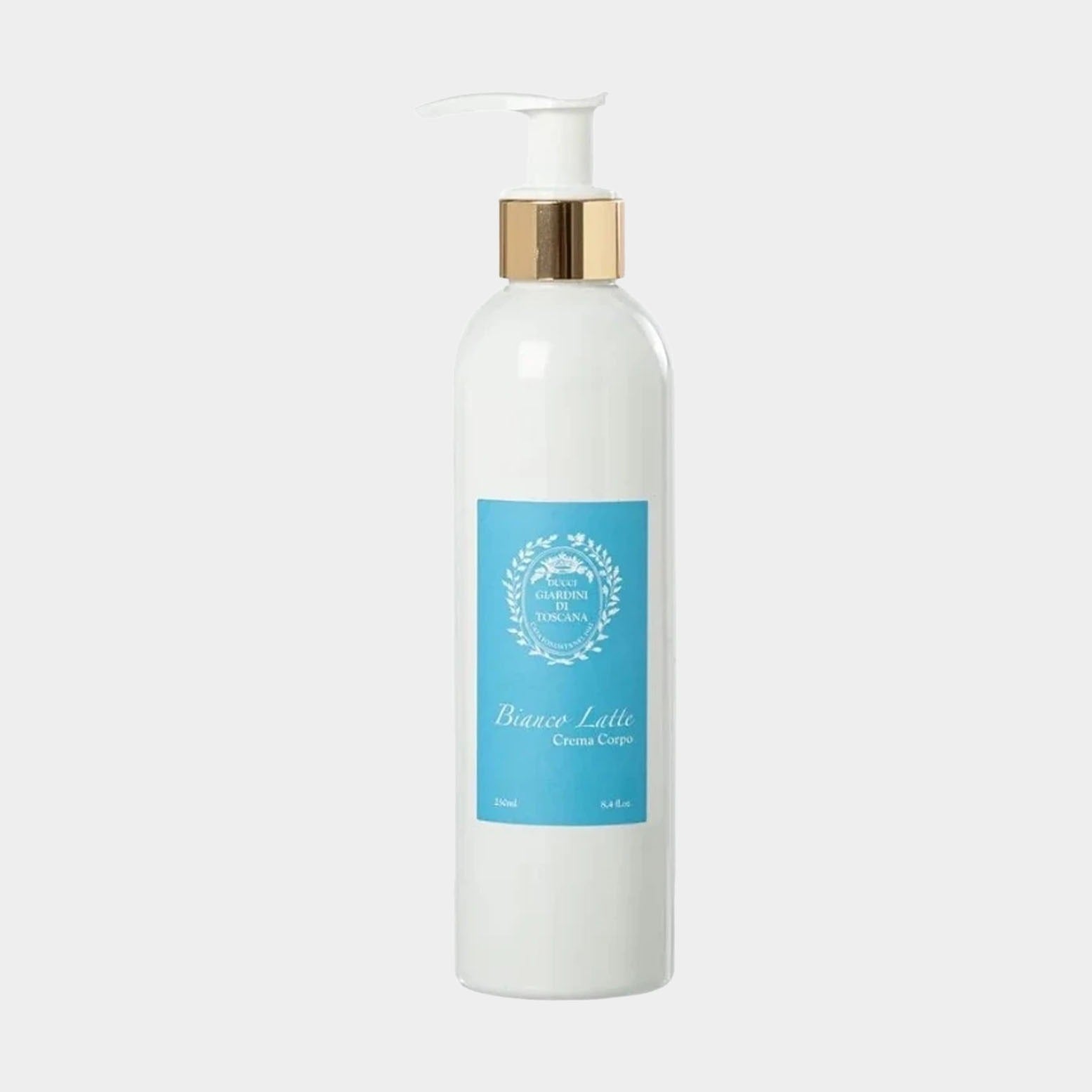 A sleek, white bottle of Giardini di Toscana Bianco Latte Bodycream with a gold pump top and a light blue label, featuring the product name and branding.