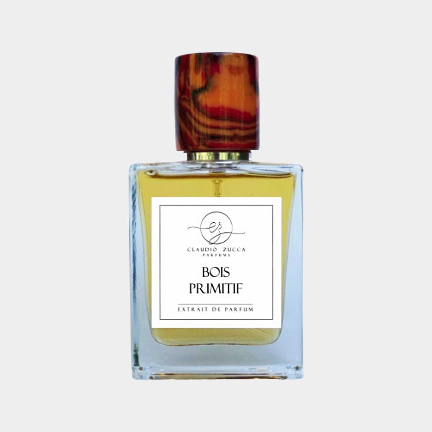 A full bottle of Claudio Zucca Bois Primitif fragrance, featuring a clear glass design with a wooden cap. The label prominently displays the name Bois Primitif along with Extrait de Parfum.